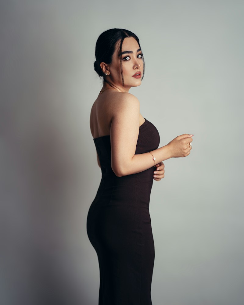 Editorial portrait of a woman in a black evening dress
